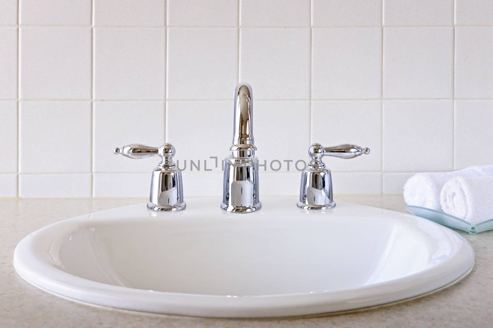 Bathroom interior with white sink and faucet