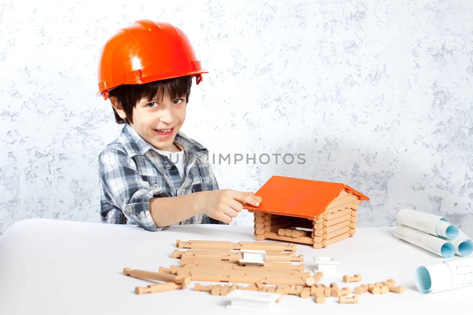 boy builder in red helmet  built a new home
