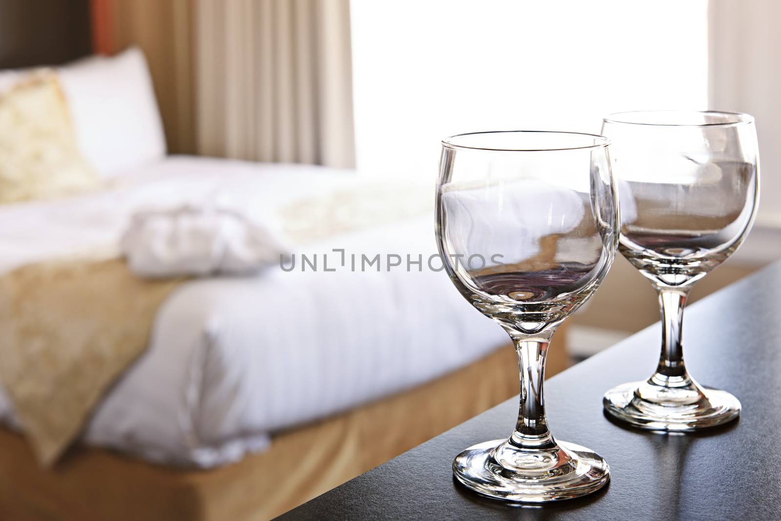 Romantic bedroom with wine glasses in luxury hotel interior