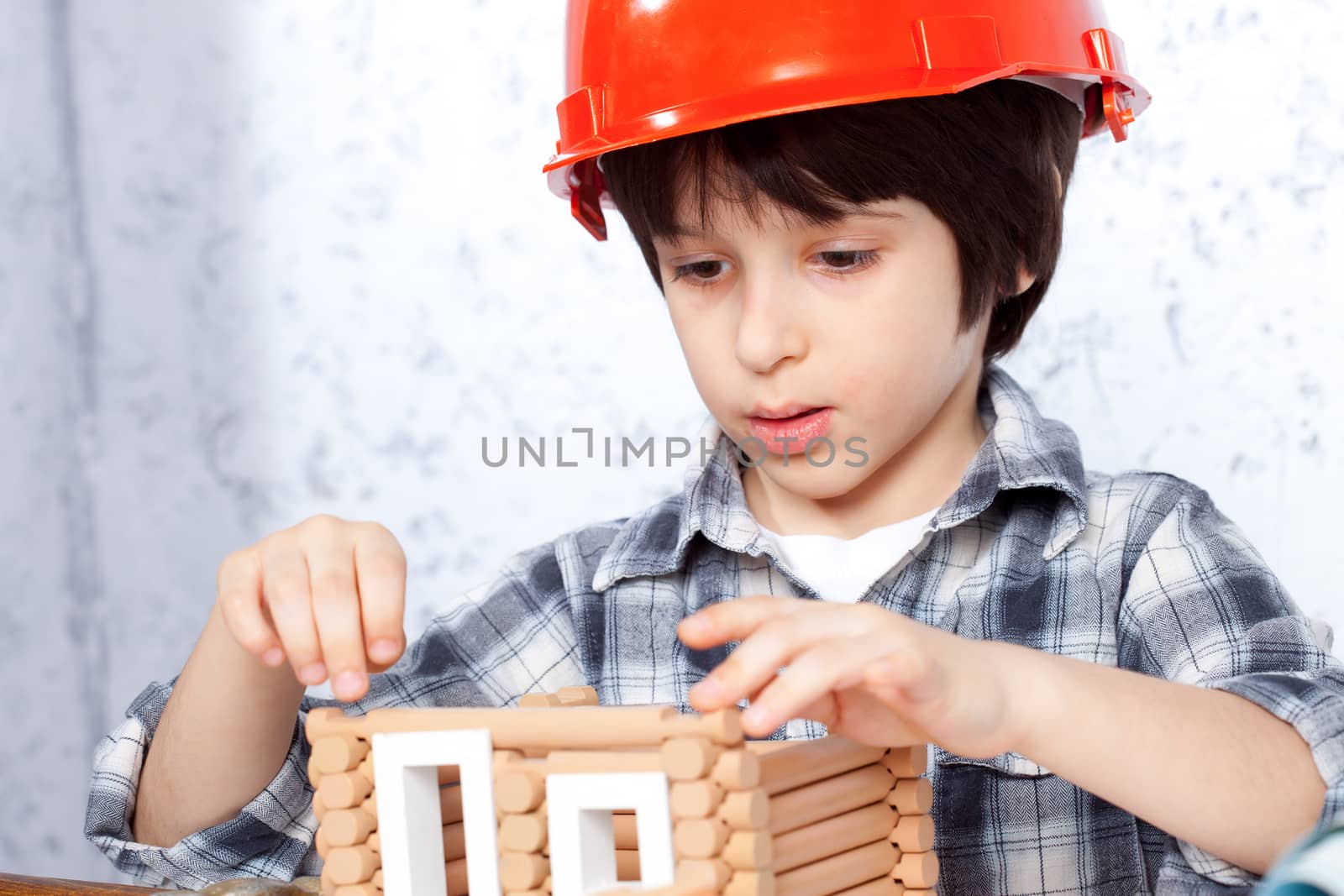 boy builder in red helmet tape built a new home