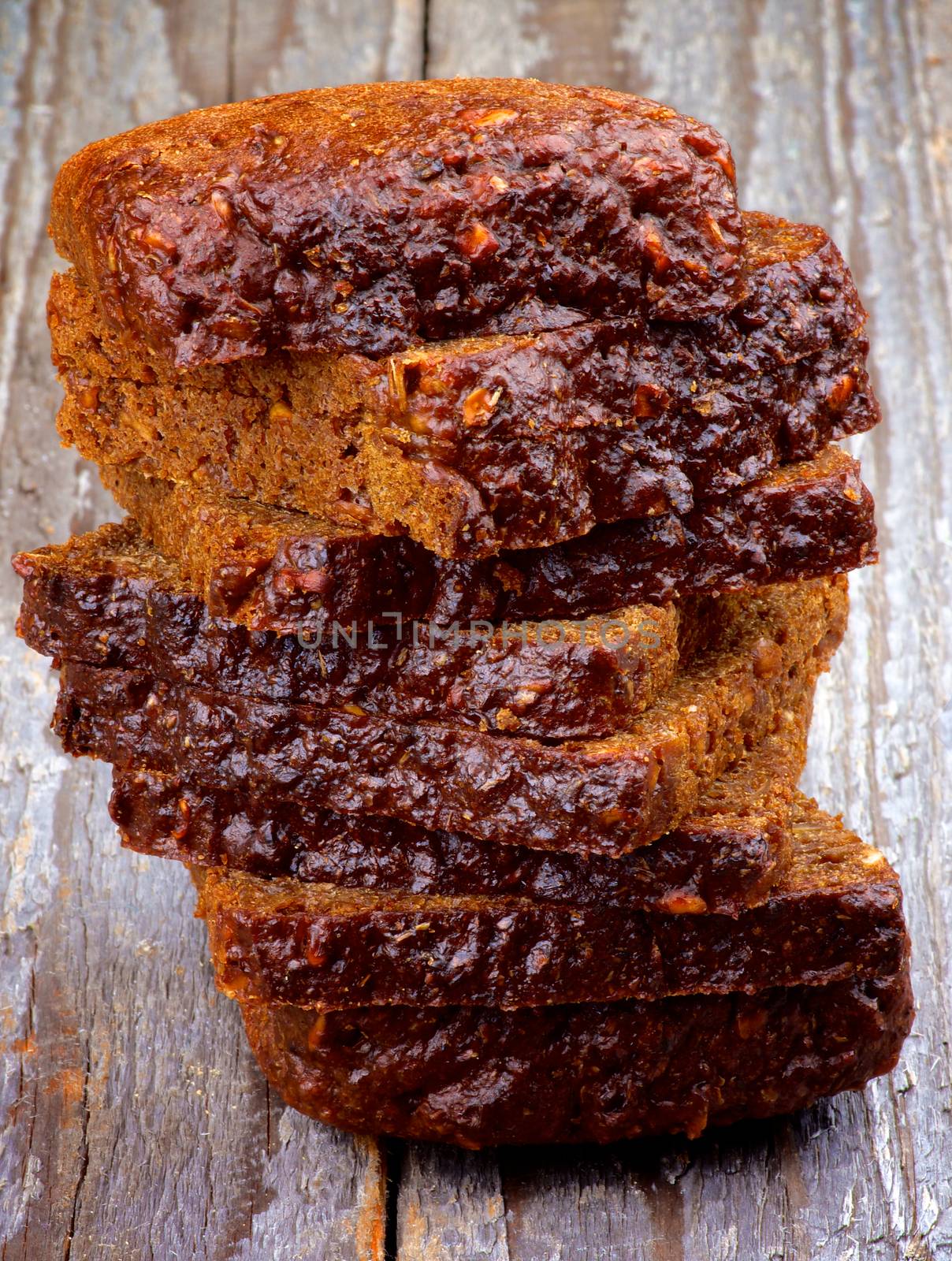 Stack of Brown 7-Grain Bread Slices closeup on Rustic Wooden background