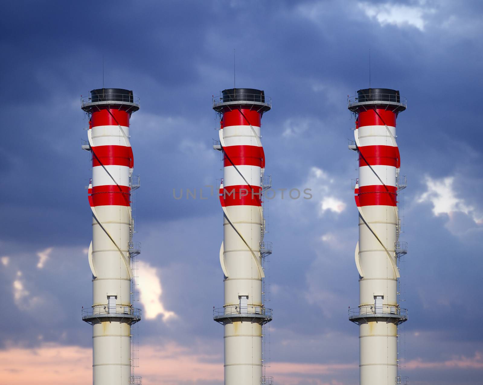 industrial chimneys on cloudy sky at sunset by FernandoCortes