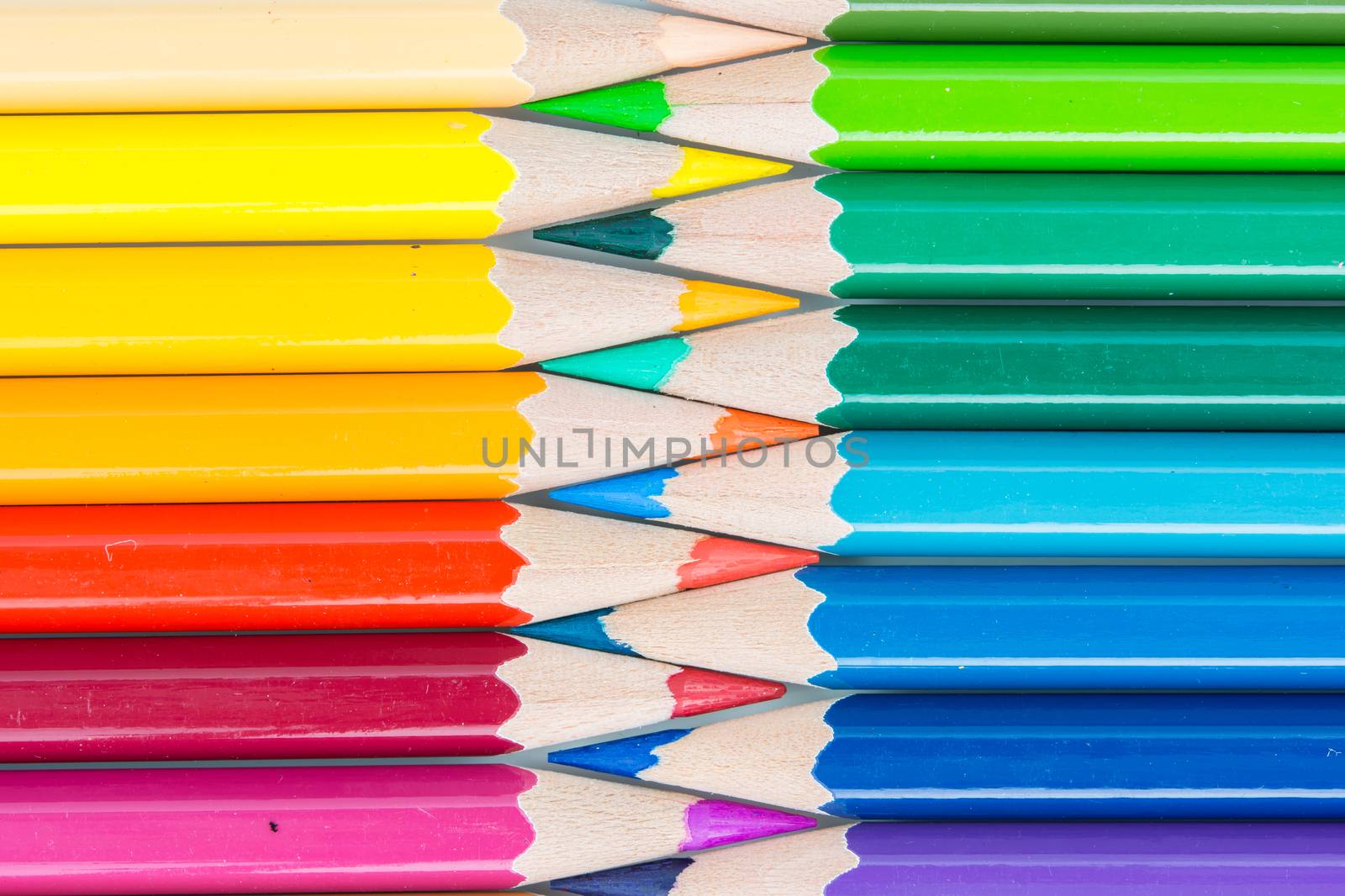 pointed color pencils and a white background