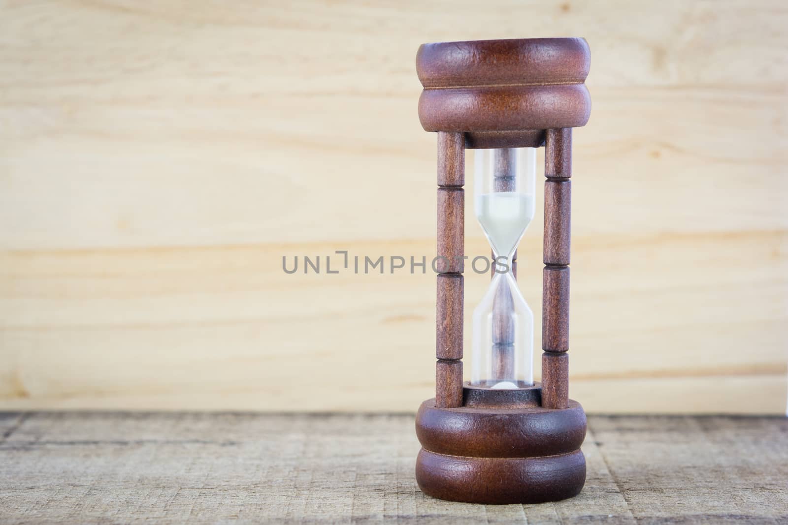 Wood hourglass countdown start on wooden background