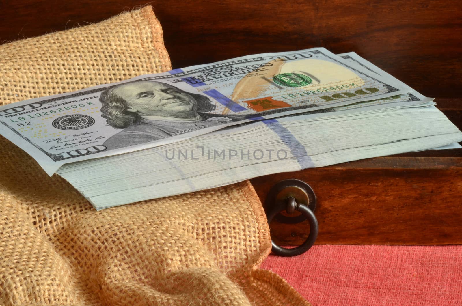 Money stored inside wooden drawer at home. New release redesigned dollar banknote.