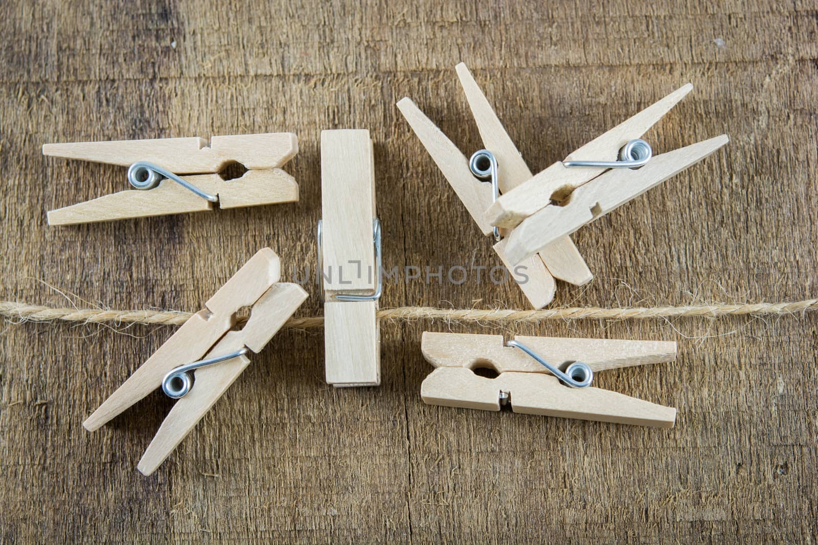 clothespin on rope isolate on wooden background