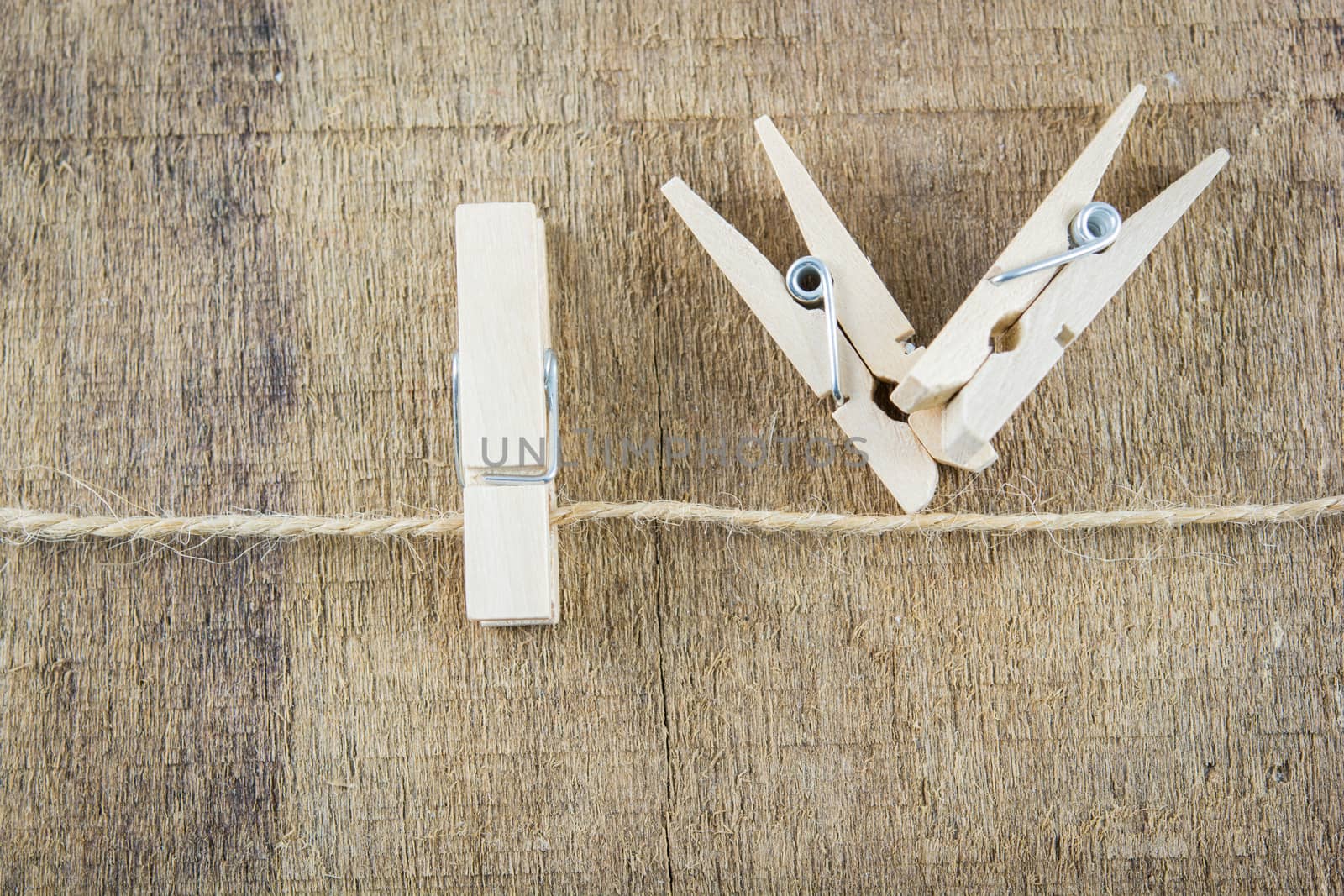 clothespin on rope isolate on wooden background