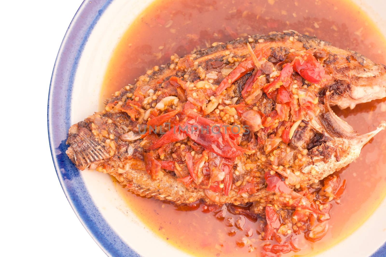 A deep fried fish topped with chili.