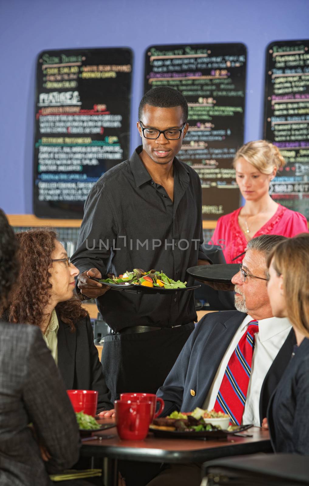 Man Serving Customers in Cafe by Creatista