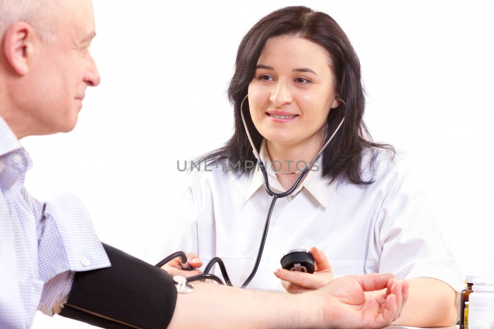 doctor measuring  blood pressure  of senior man by manaemedia