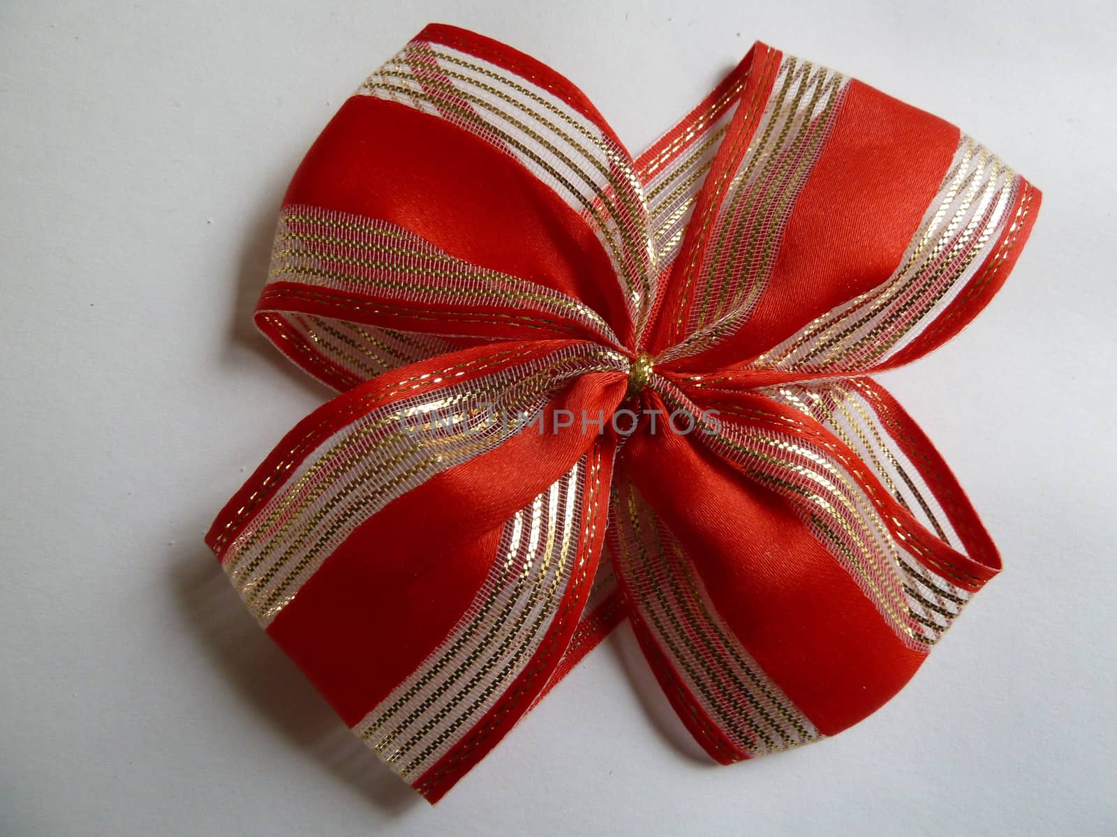 Bright red and gold ribbon on a white background