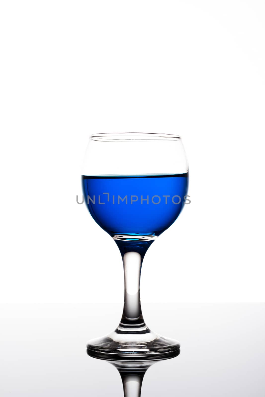 Classy colrfull backlit  glass with blue drink and reflection