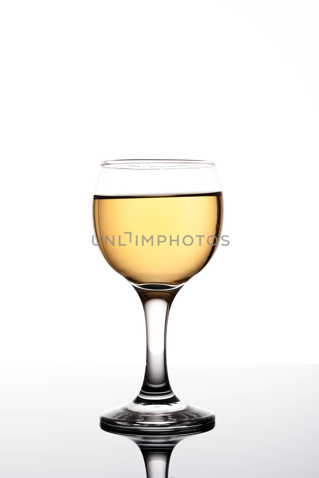 Classy colrfull backlit  glass with yellow drink and reflection