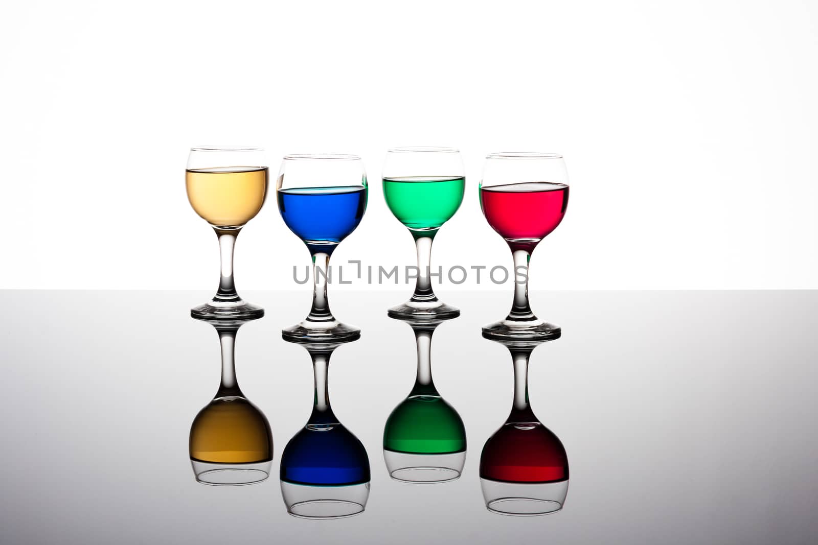 red, green, yellow and blue backlit drinks with reflection