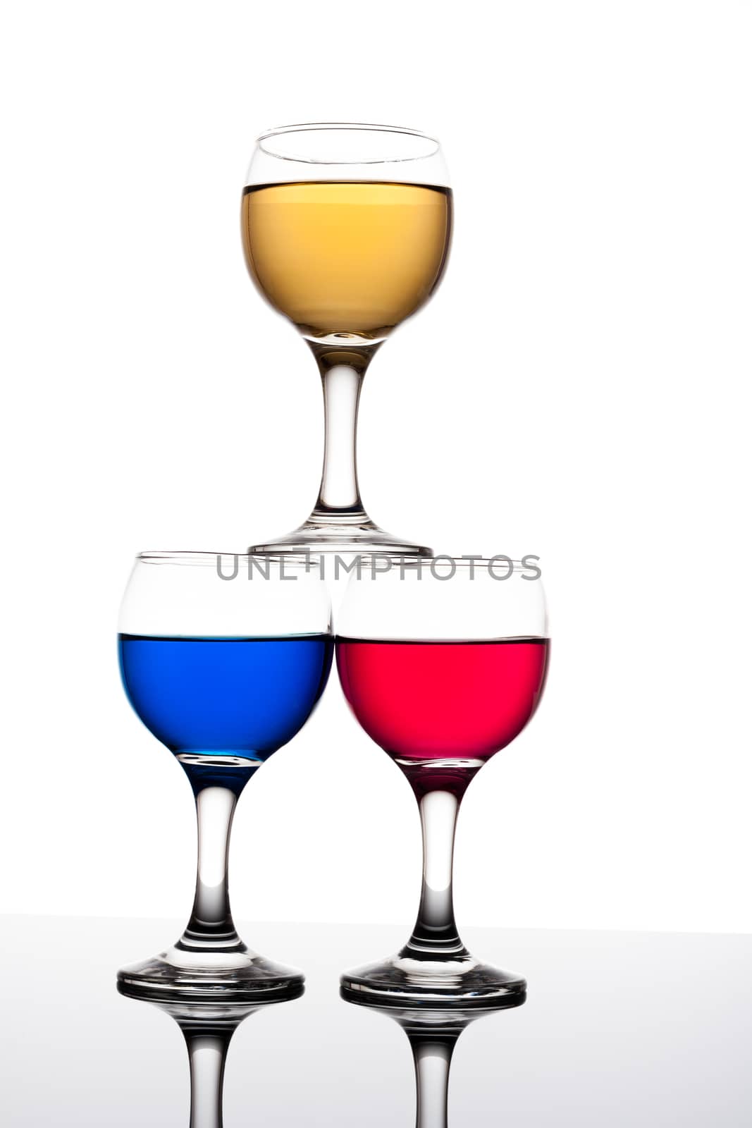red, yellow and blue backlit drinks with reflection