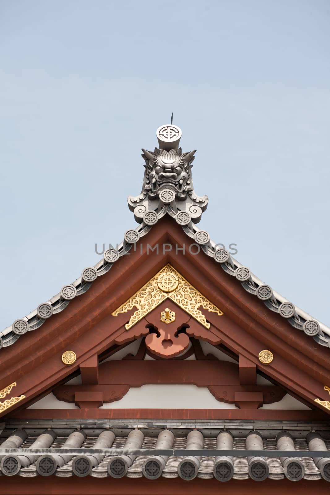 Detail on japanese temple roof against blue sky by 2nix