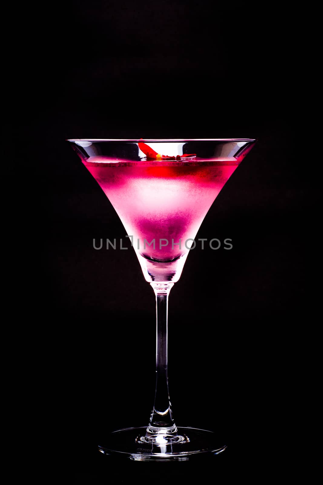 Cosmopolitan cocktail with rose in top of a black background