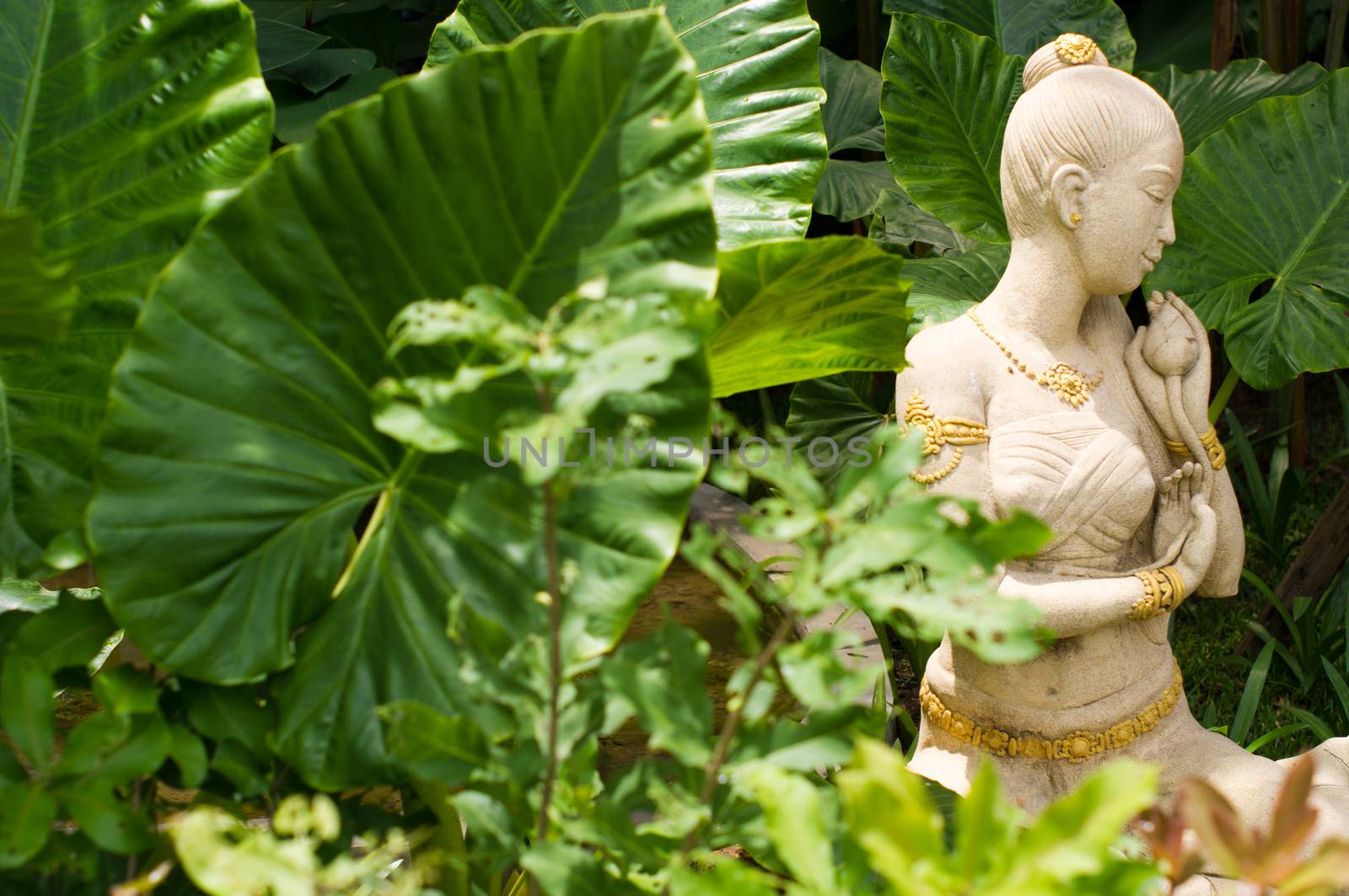 A female sculpture in a garden