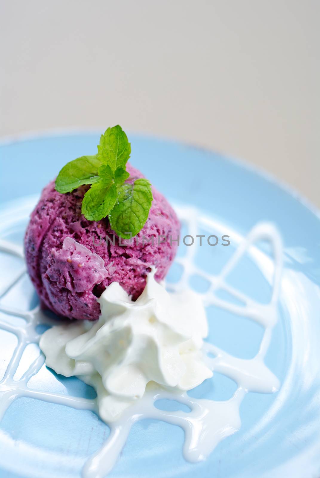 Ice-cream with a currant and mint on a table