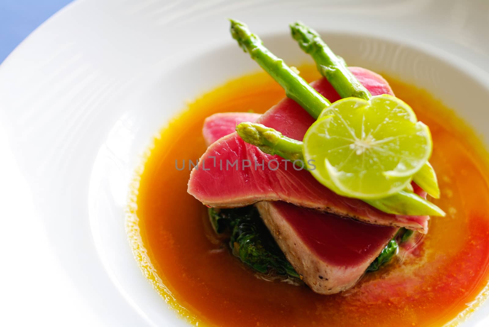 Raw Steak with lemon and asparagus