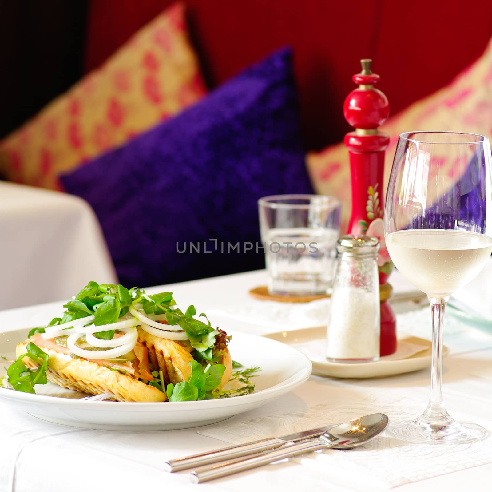 Fine restaurant dinner table place setting: napkin, wineglass