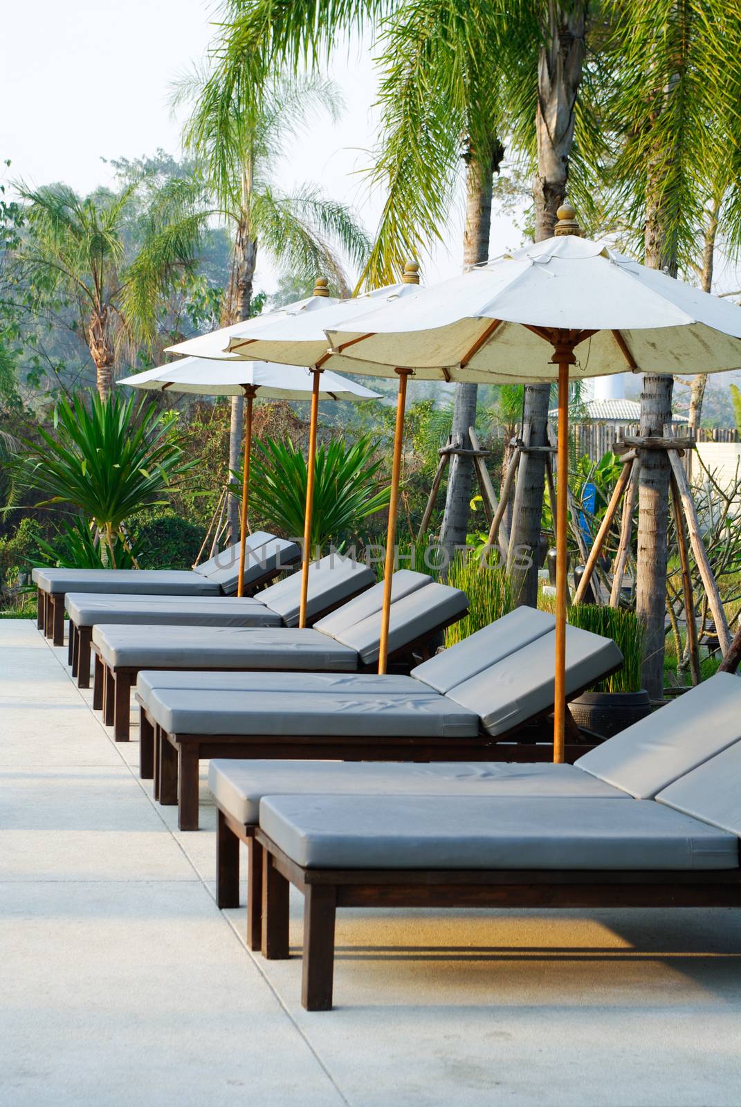 Sunbed beside swimming pool , Thailand