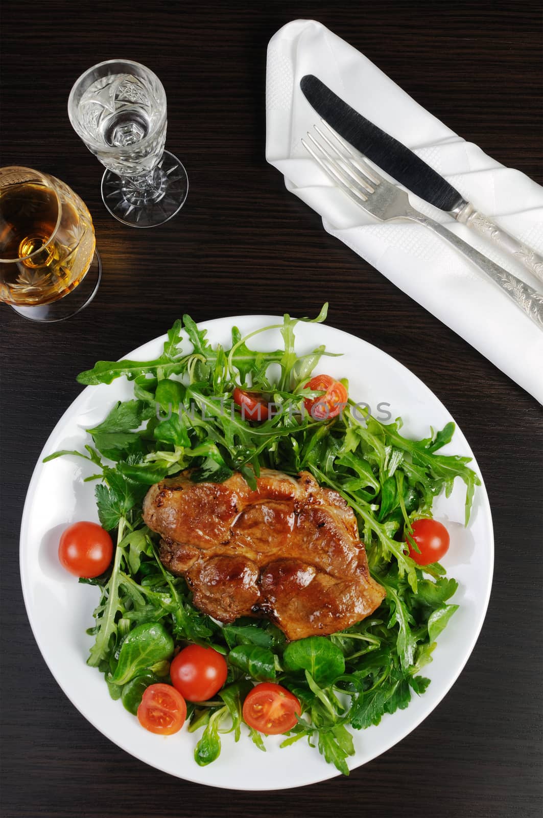 Grilled steak with bacon salad of arugula 