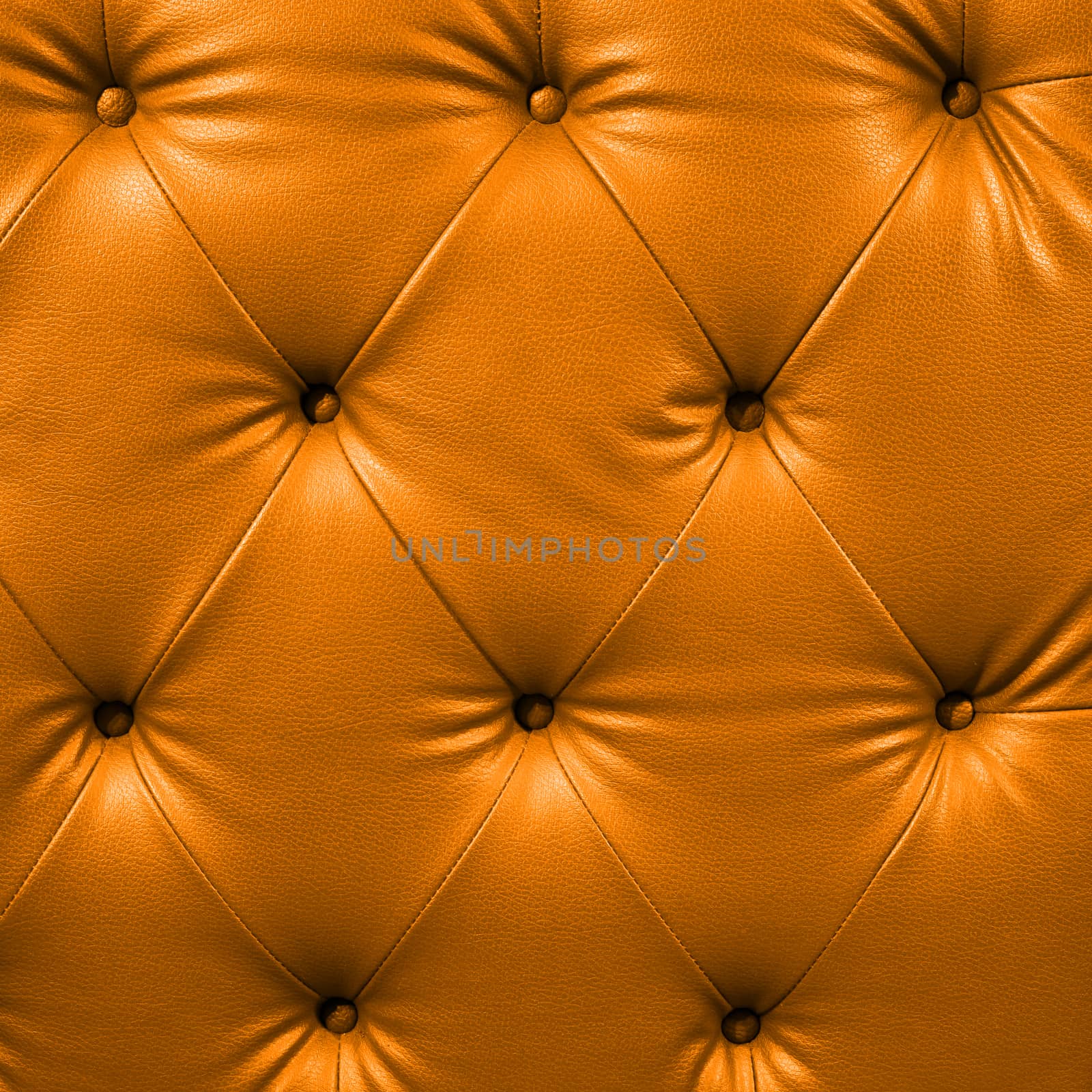 Close up orange luxury buttoned black leather