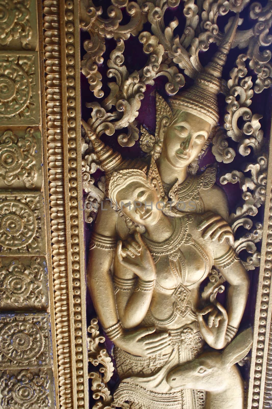 golden figure in a buddhist temple in luang prabang in laos