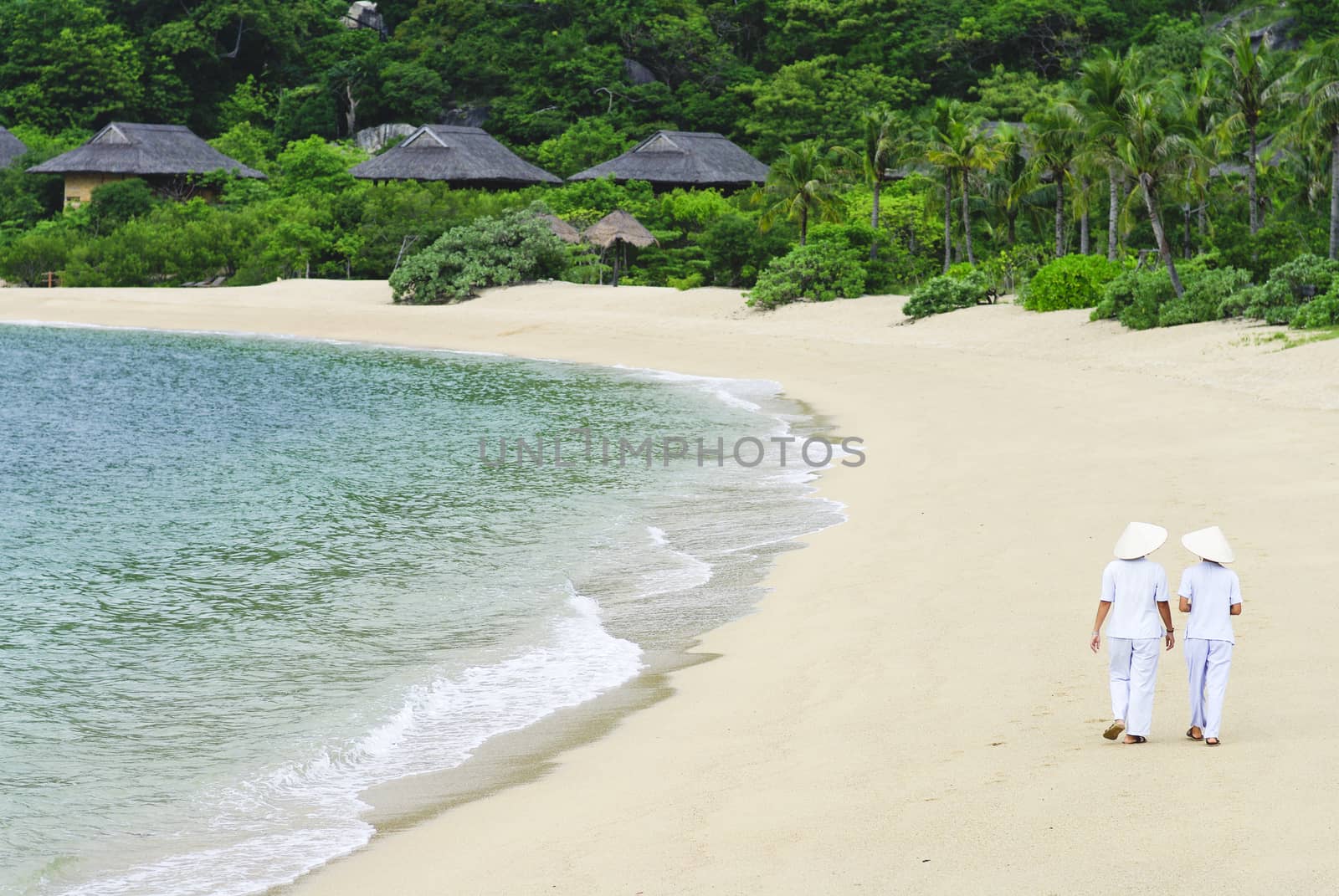Vietnamese Woman walking on the beach