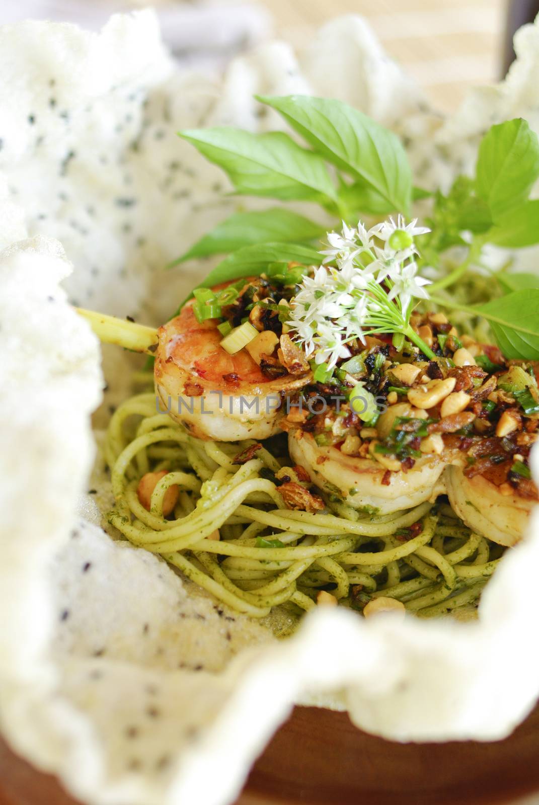 plate of green spaghetti broccoli pesto and prawn ready for serve
