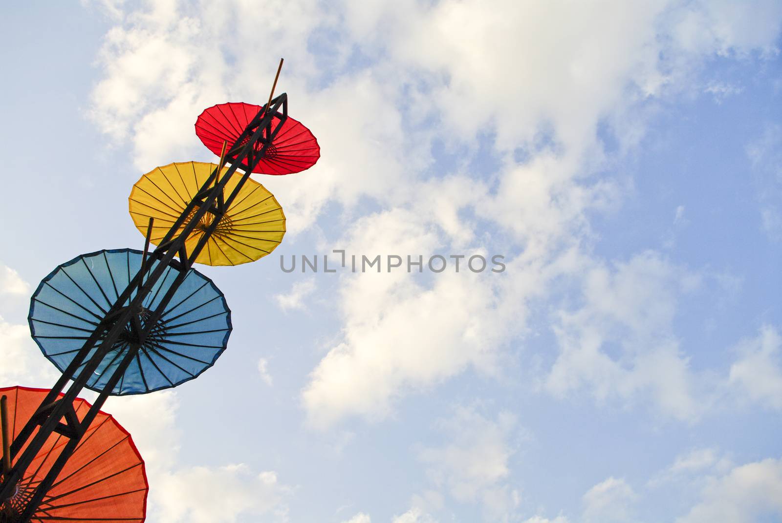 Colorful umbrella on blue sky