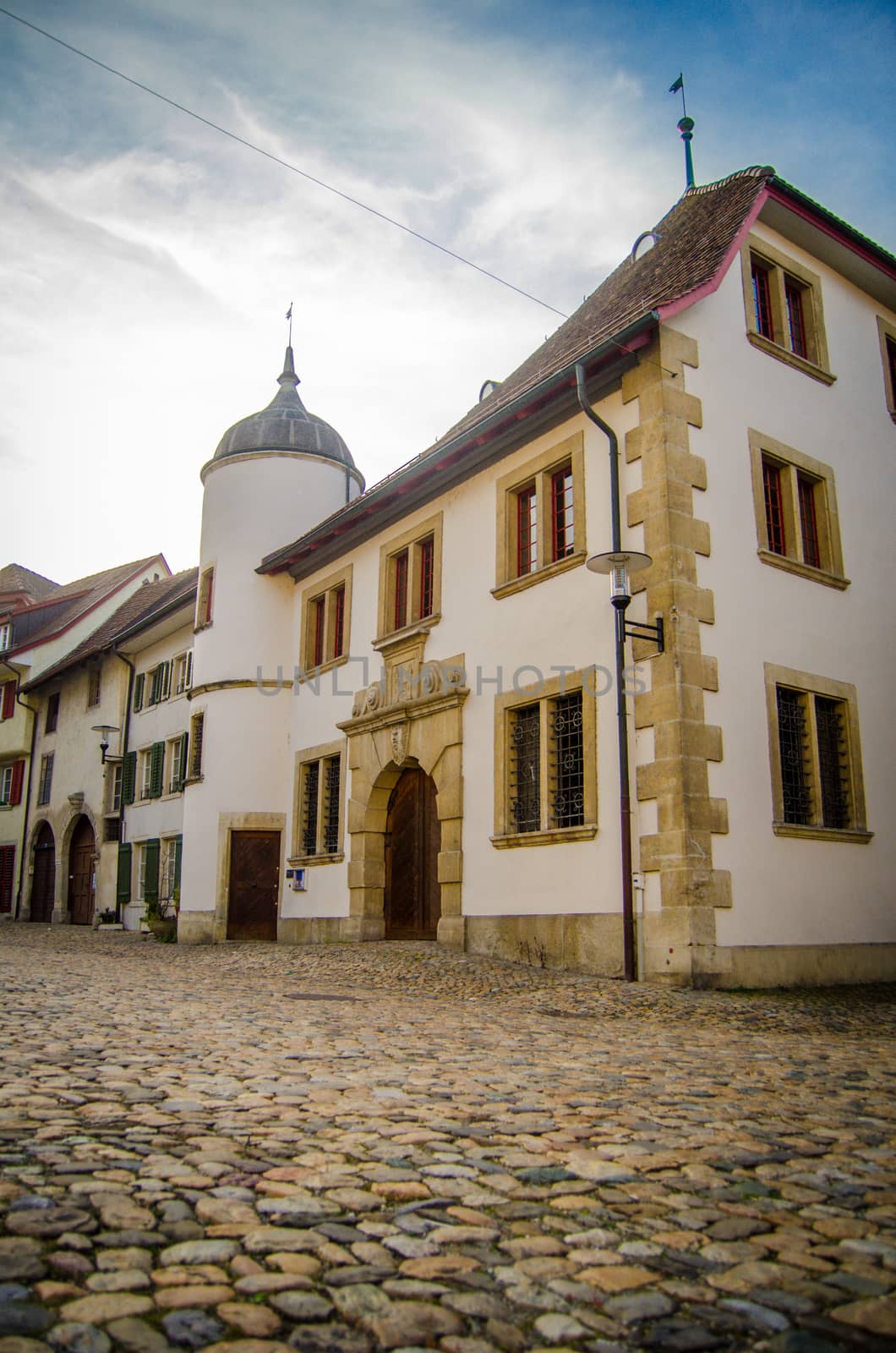 Traditional Buildings On An Empty Cobbled Street In A Town In Europe