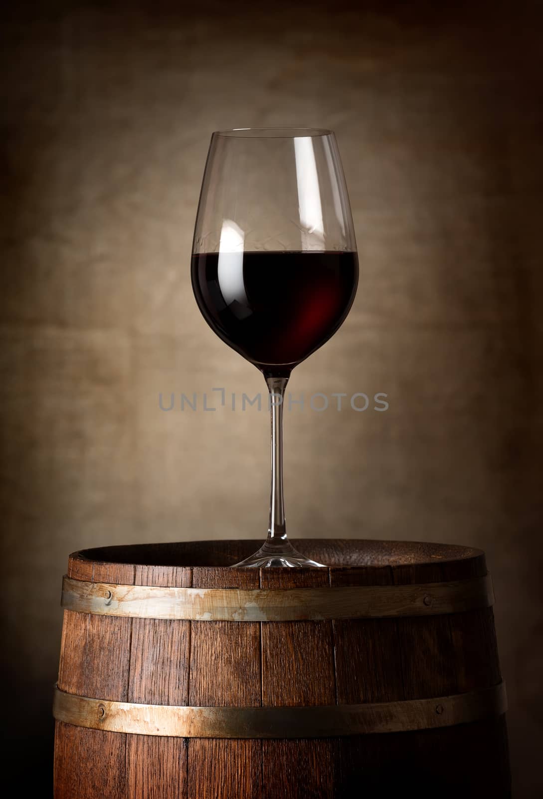 Red wine and barrel on a background of a canvas