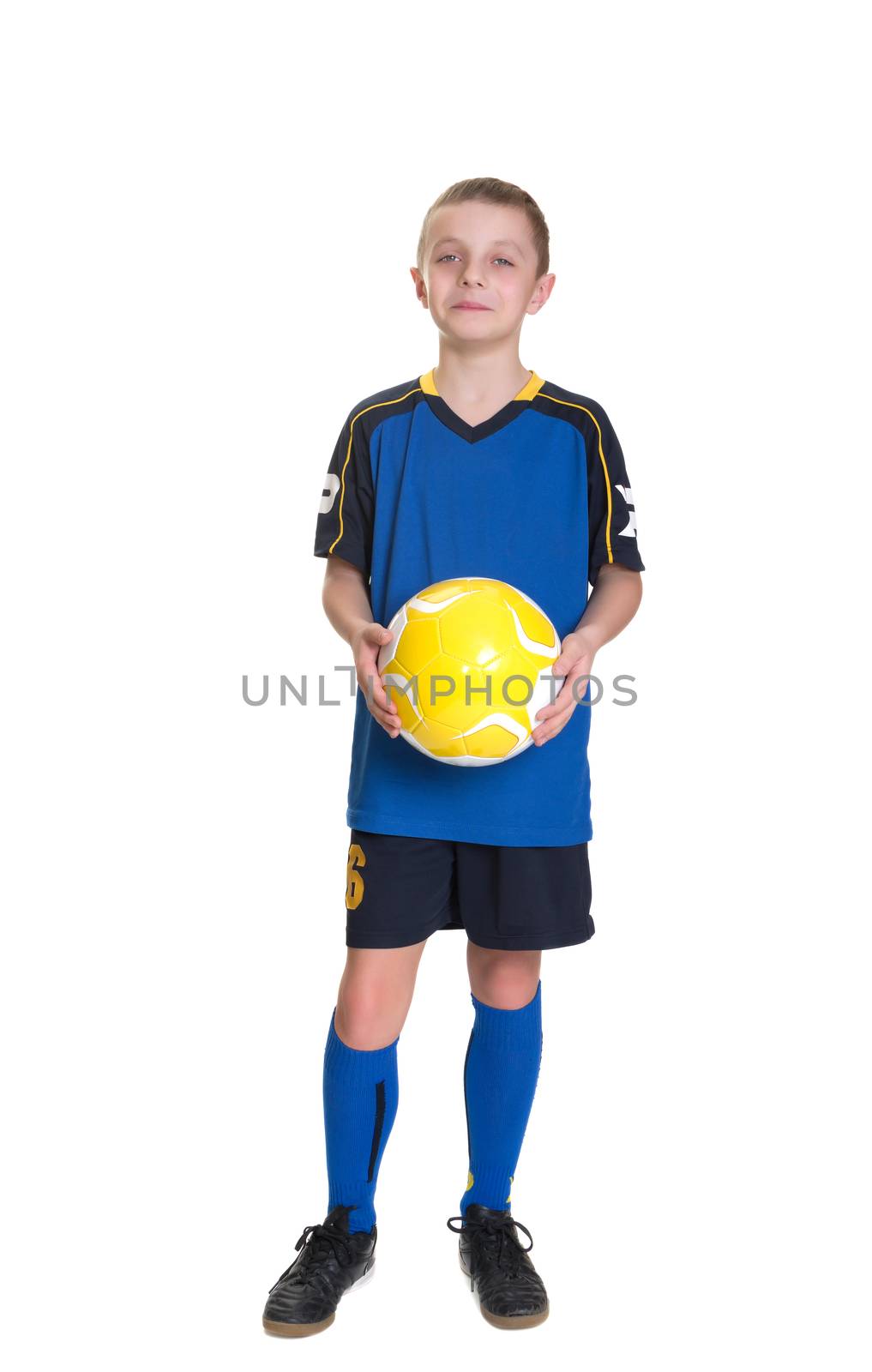 Smiling boy with a soccer ball isolated on a white background.