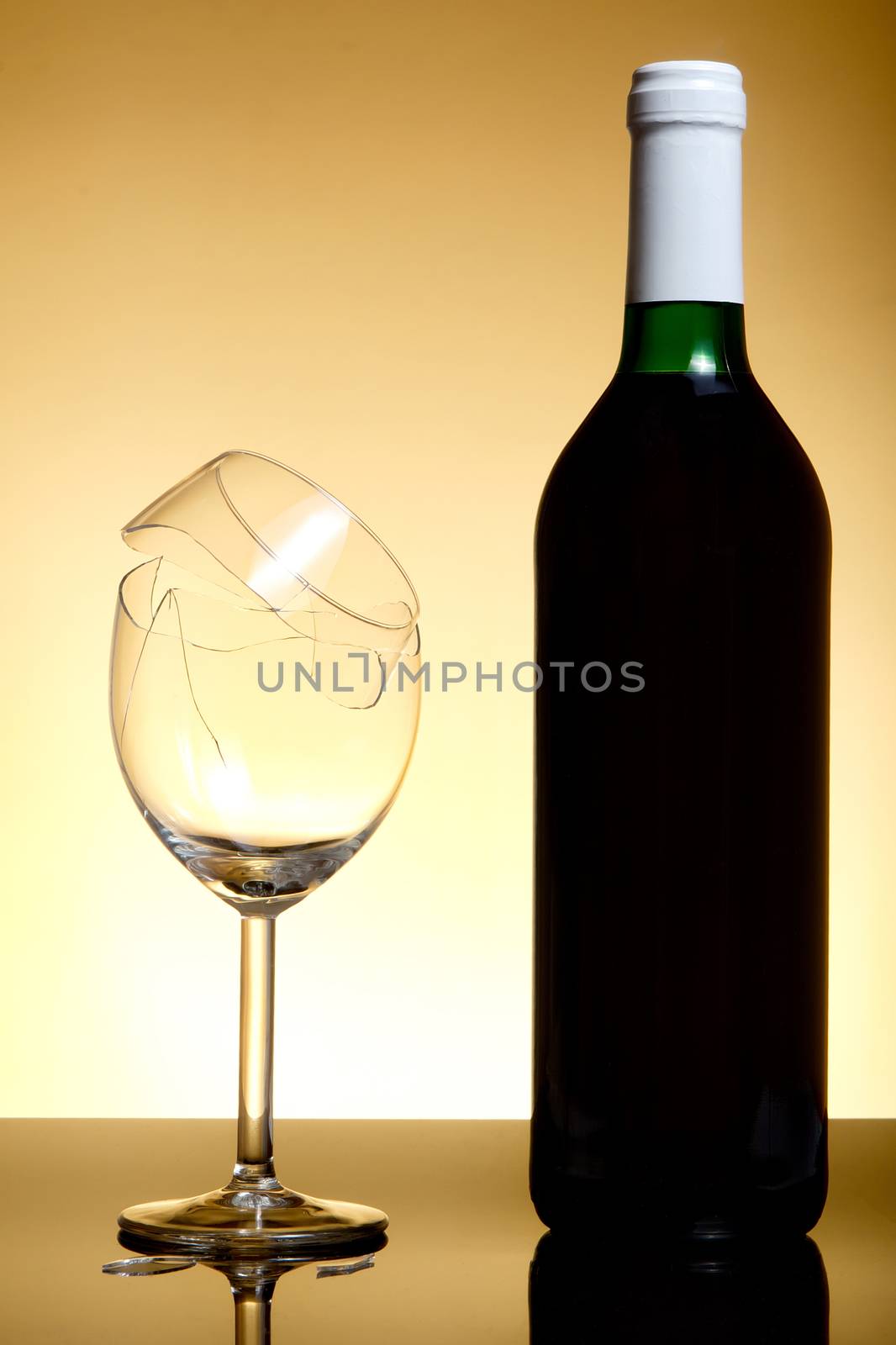 Vine bottle and broken glass on orange background by anderm