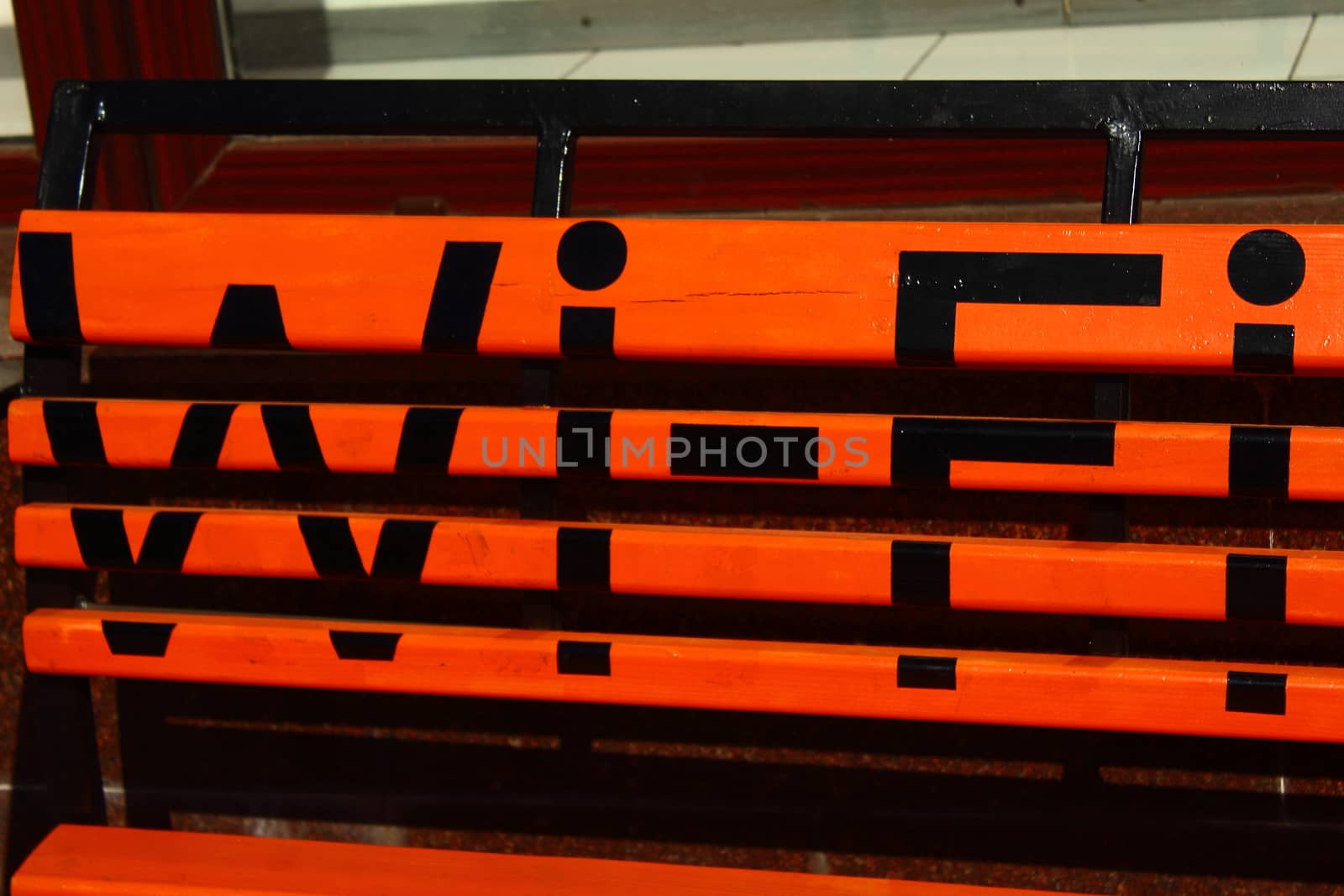 orange bench on which is written in black Wi- Fi
