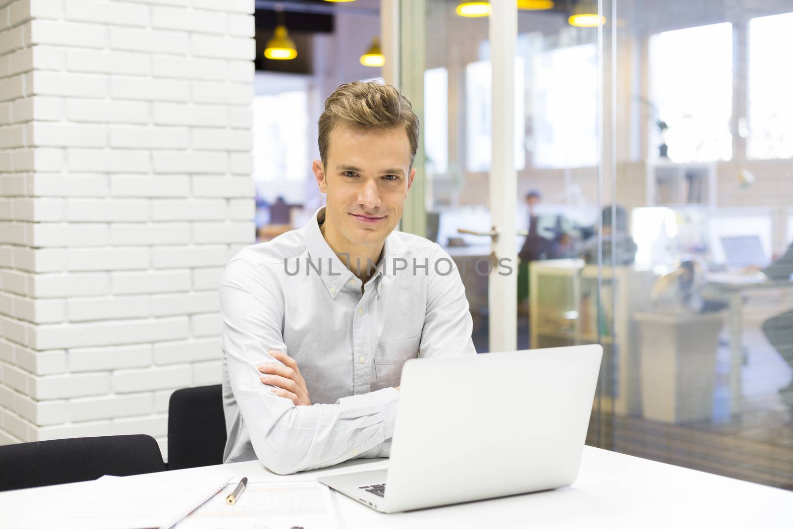 Man working at his laptop on the office in start-up by LDProd