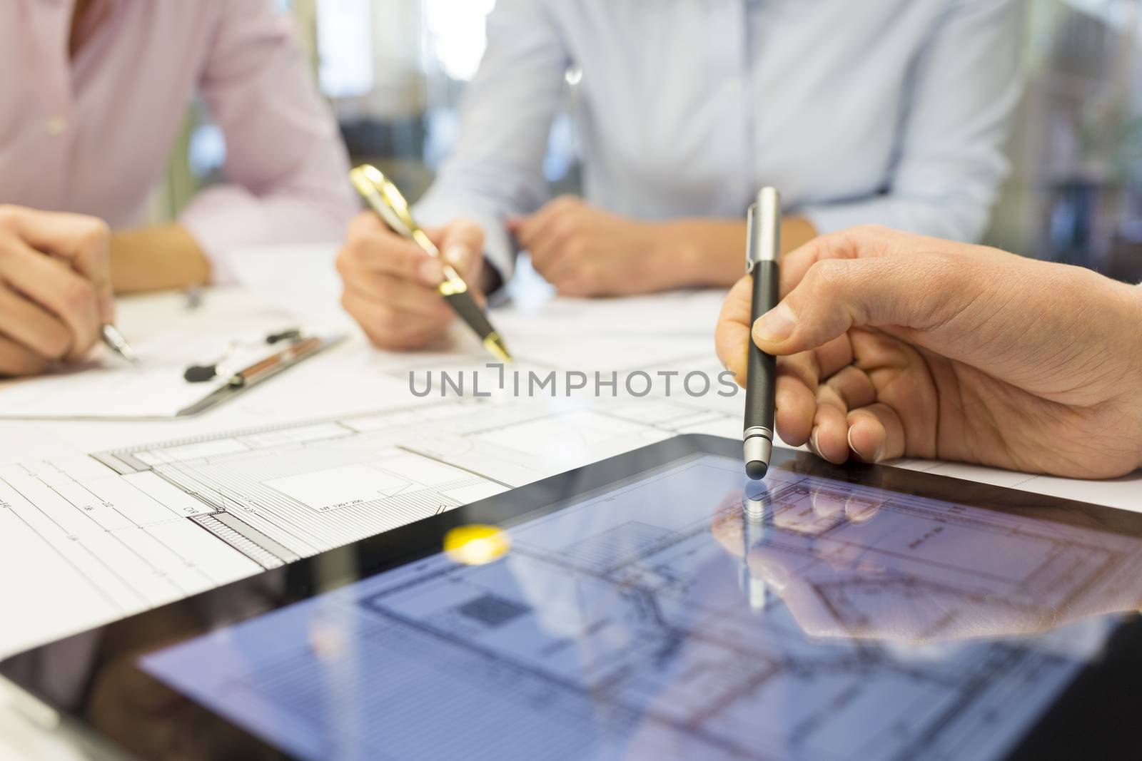 Close-up of Team architects working on construction project by LDProd