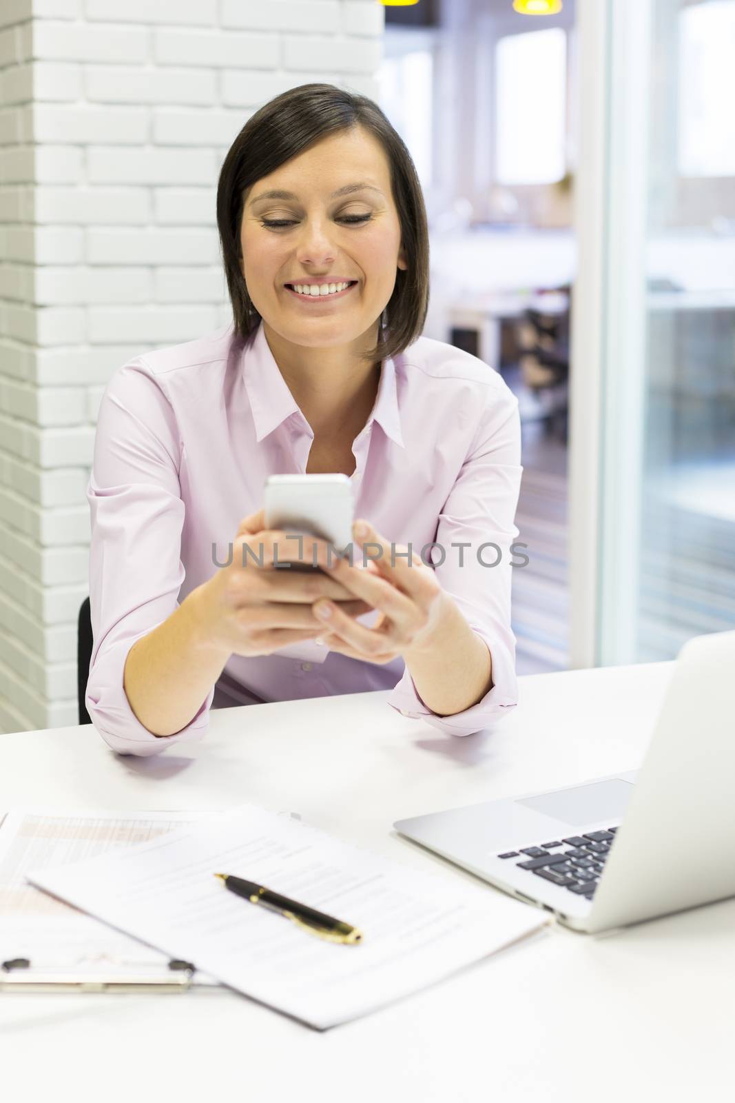 Female business cell phone desk typing