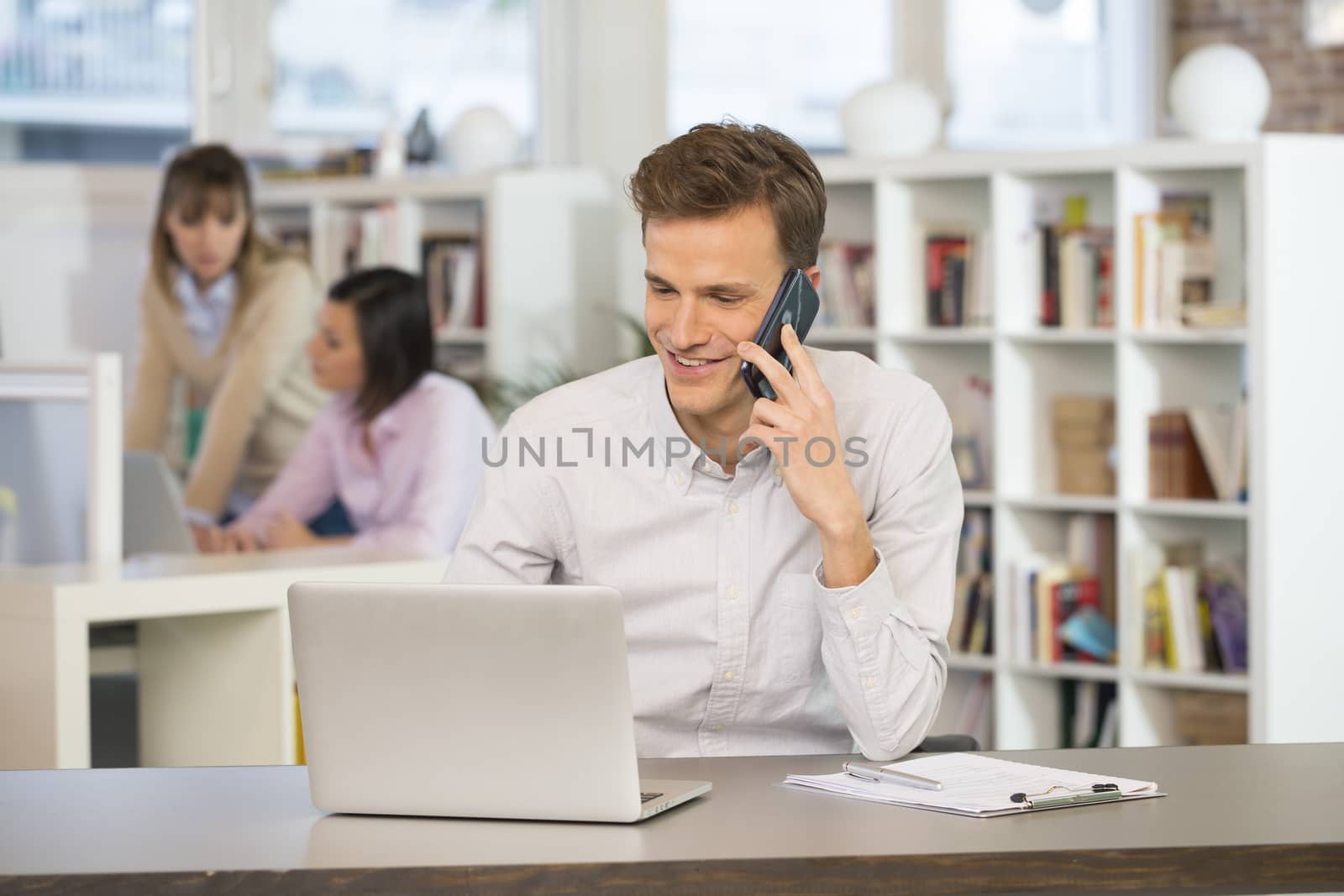 Happy Businessman on phone in office by LDProd