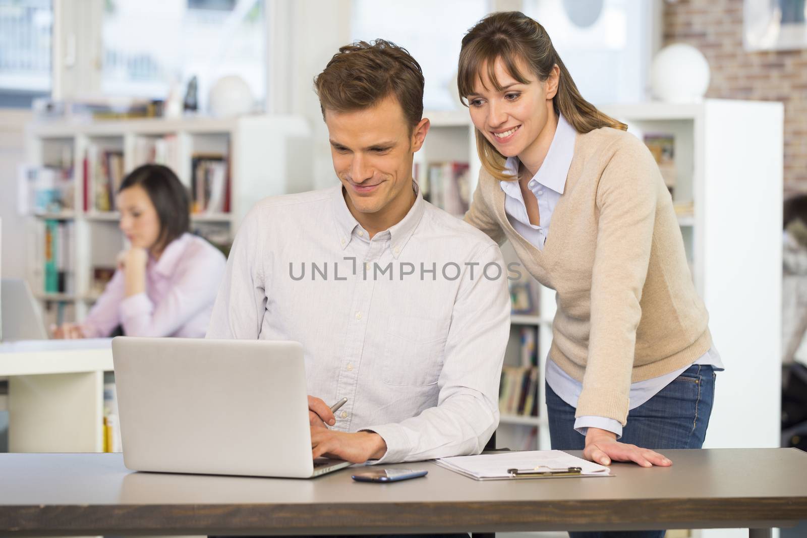 Businesspeople happy desk laptop casual