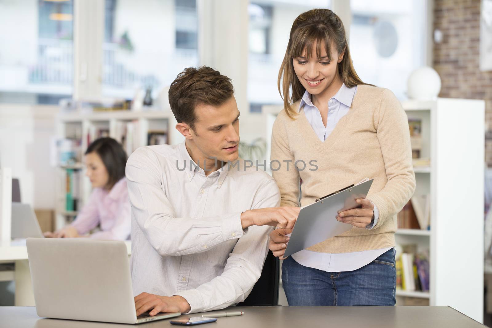 Businesswoman businessman cheerful desk talking