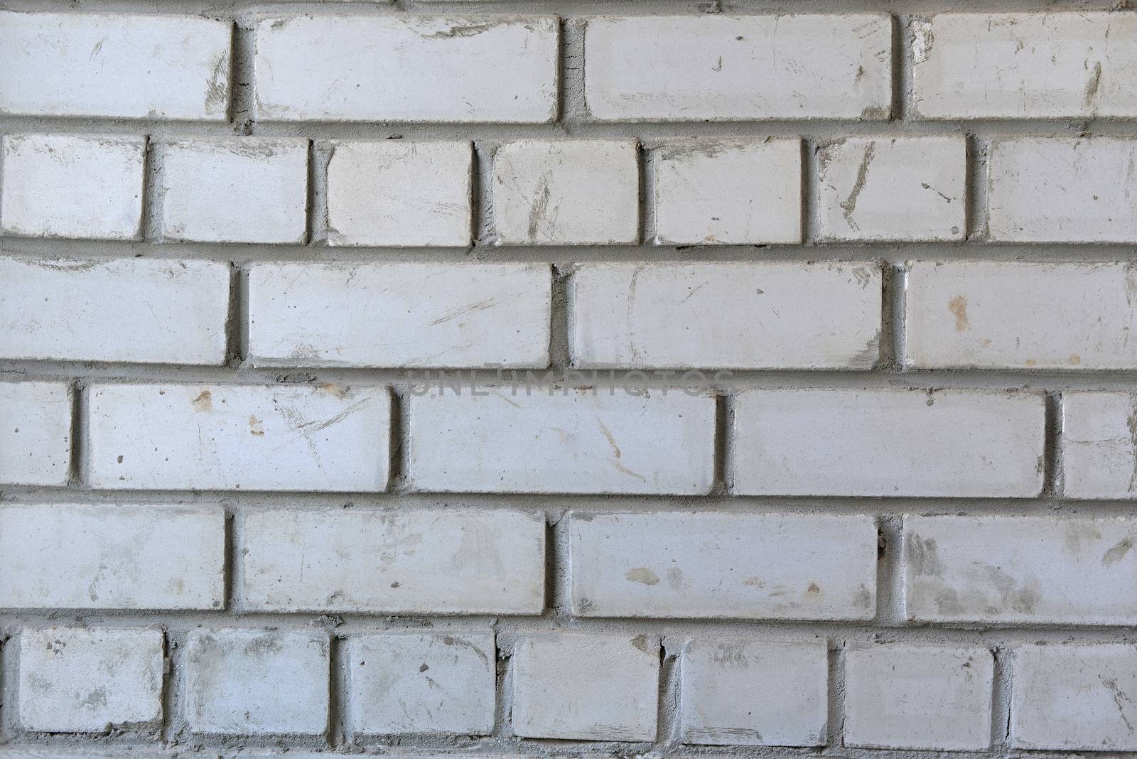 White brick wall. Concrete, cement and dirt