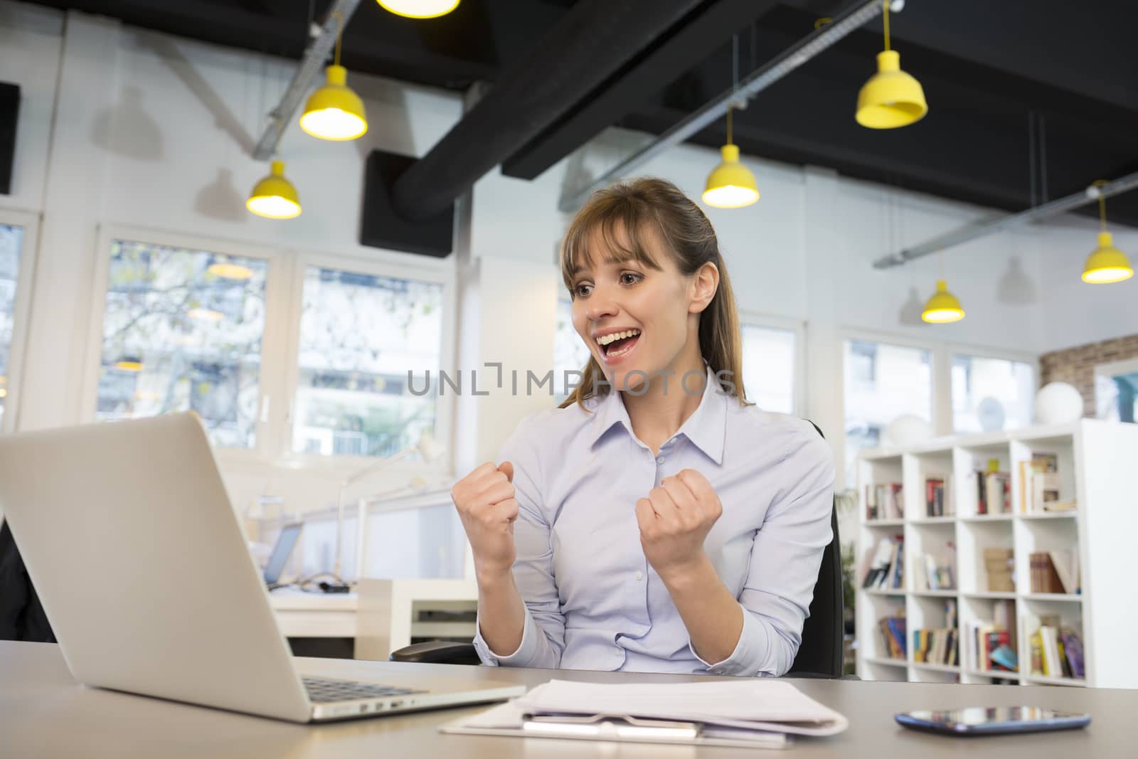 Happy Successful  businesswoman in office, with arms up by LDProd