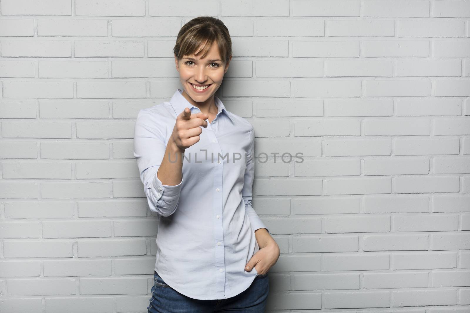Female casual happy studio point fingers gray isolated background
