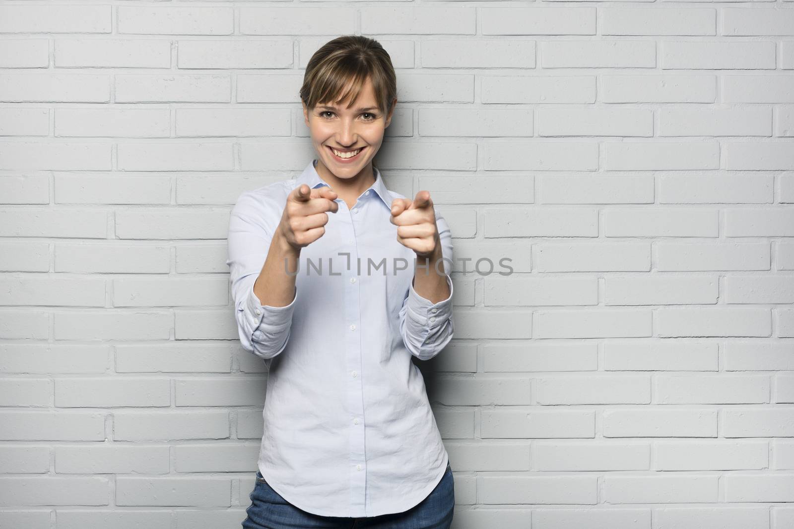 Female casual happy studio point fingers gray background
