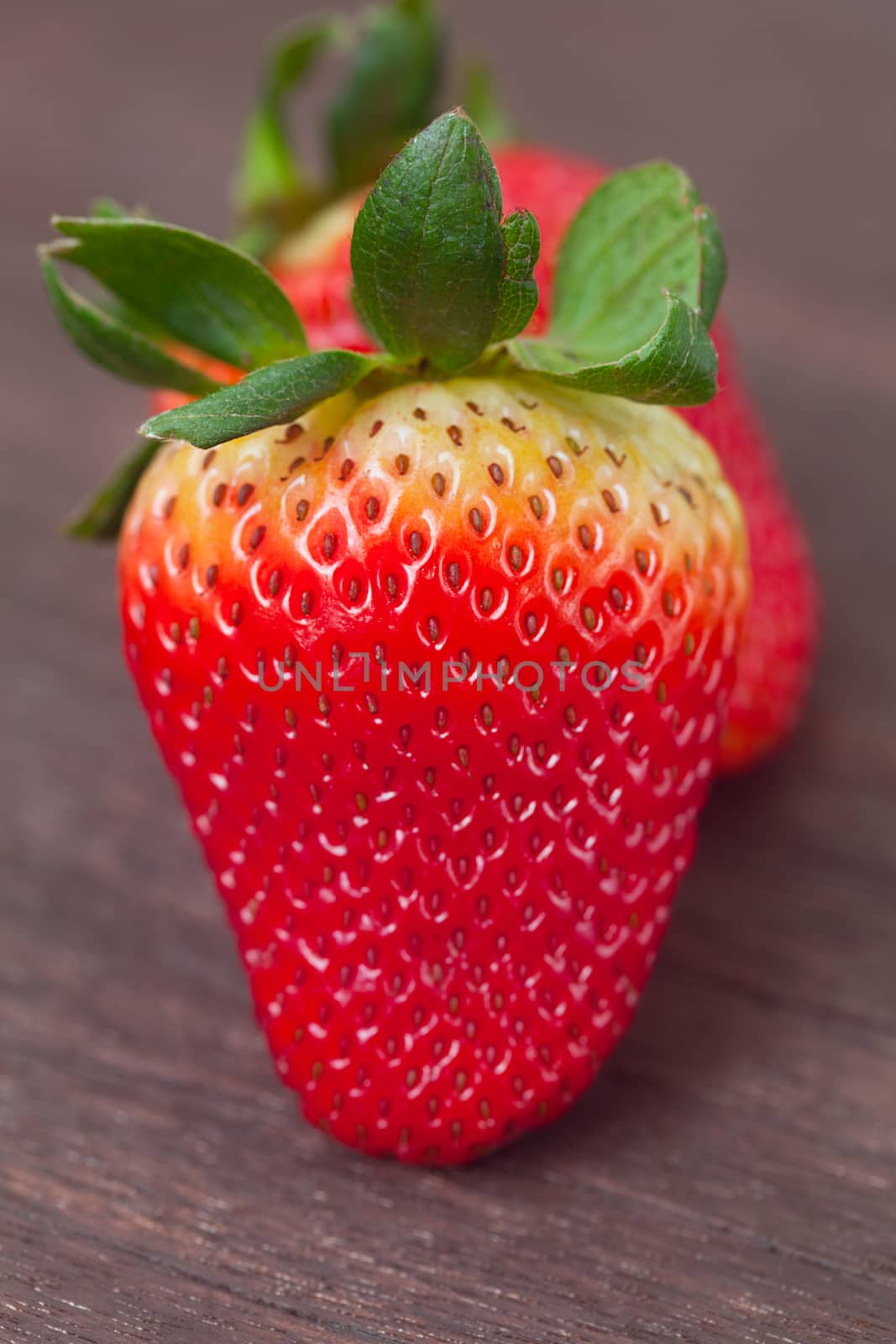 red juicy strawberry  on a wooden surface