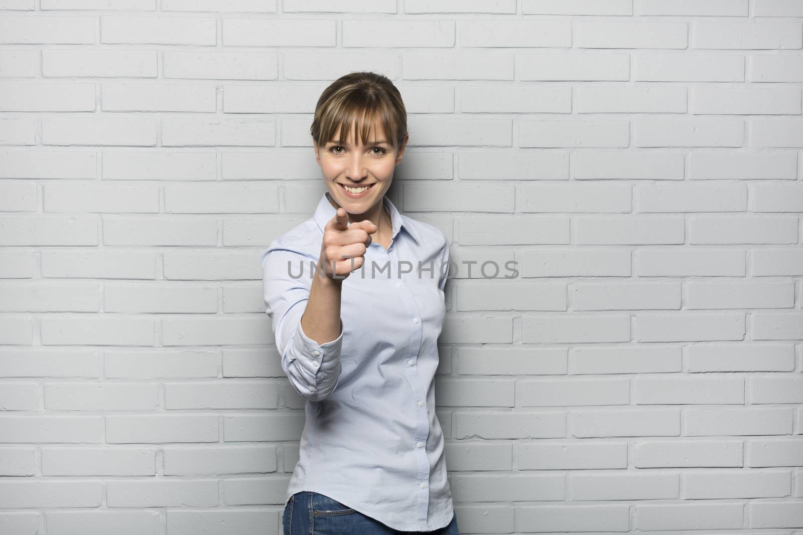 Female casual happy studio point fingers gray isolated background