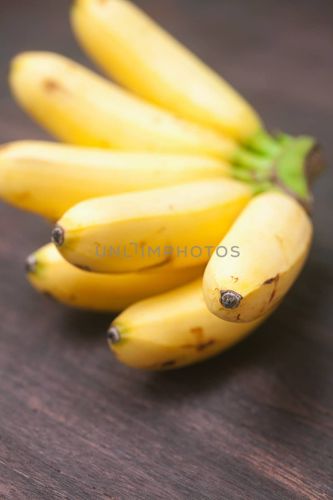 bunch of bananas on a wooden surface